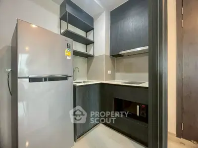 Modern compact kitchen with sleek appliances and minimalist design