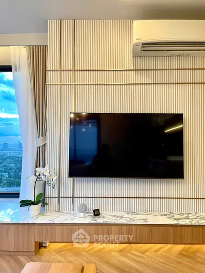 Modern living room with wall-mounted TV and city view window
