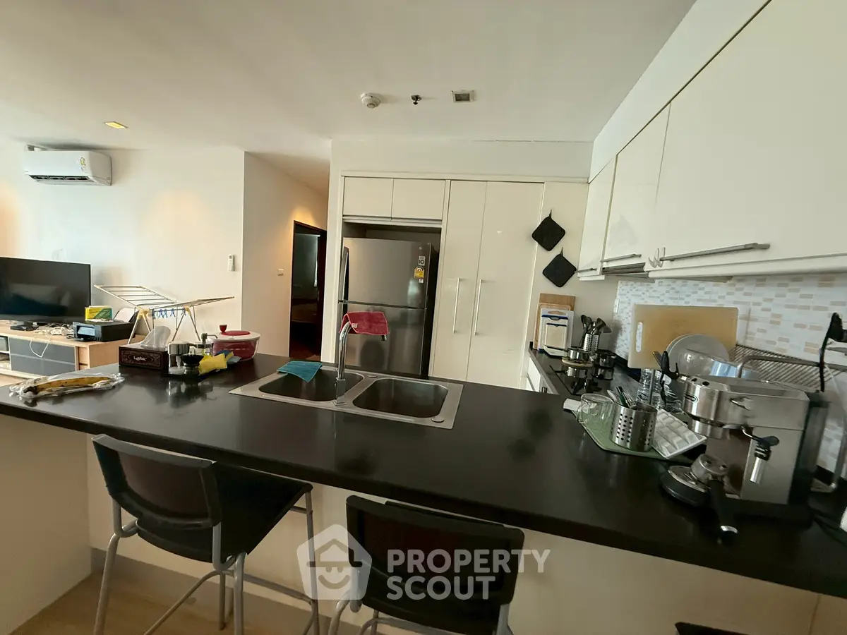 Modern kitchen with sleek black countertop and stainless steel appliances