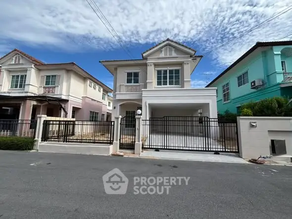 Charming two-story house with gated driveway in a serene neighborhood, perfect for family living.