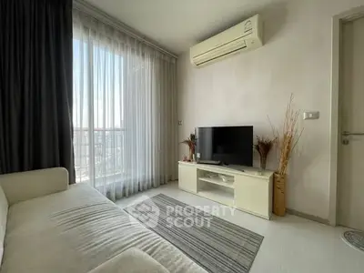 Modern living room with air conditioning and balcony view, featuring a cozy sofa and sleek TV setup.