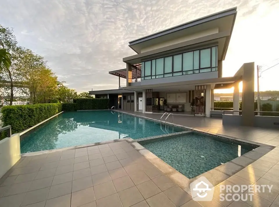 Luxurious modern house with stunning pool and sunset view, perfect for relaxation and entertainment.