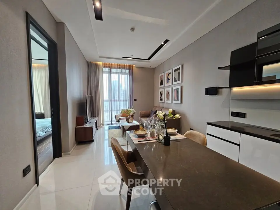 Modern open-plan living and dining area with sleek kitchen and stylish decor
