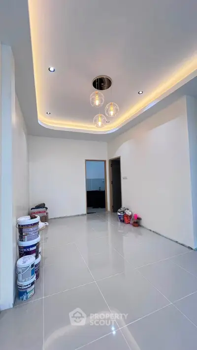 Modern living room with sleek lighting and glossy tiled floor, perfect for contemporary living.