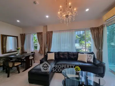 Luxurious living room with elegant chandelier and spacious seating area, perfect for relaxation and entertaining.