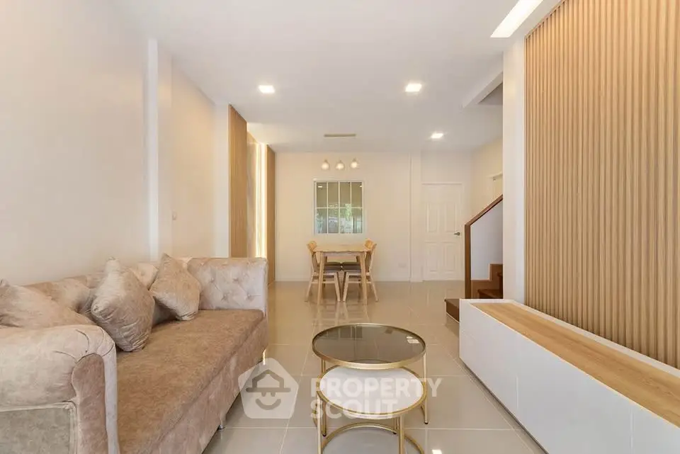 Elegant living room with plush sofa and modern decor in a spacious open layout.