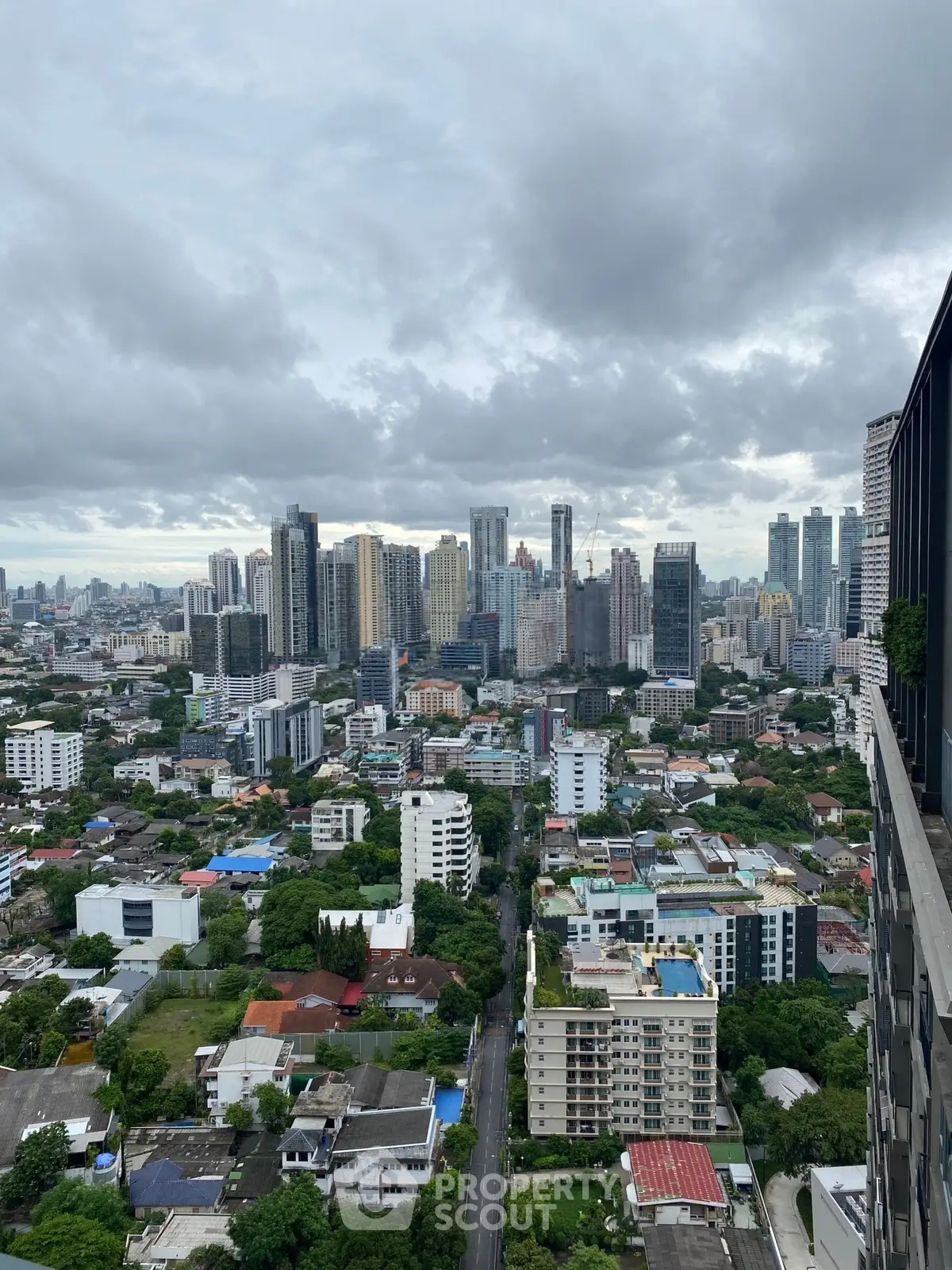 Stunning cityscape view from high-rise building showcasing urban skyline and residential area.