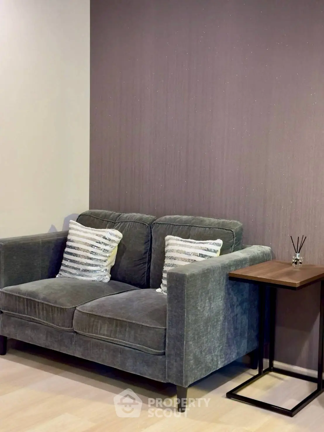 Cozy living room with plush grey sofa and stylish side table