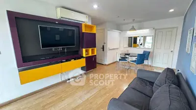 Modern living room with stylish furniture and entertainment center in a cozy apartment.