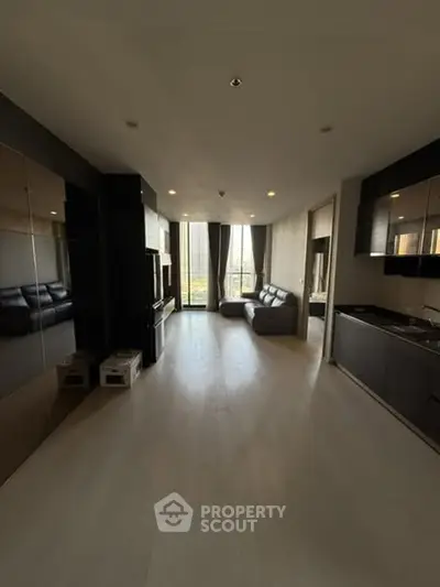Spacious modern living room with open kitchen and large windows