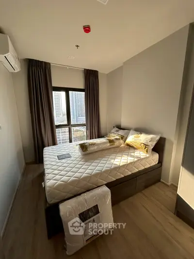 Modern bedroom with large window and stylish decor in urban apartment