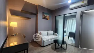 Modern living room with cozy sofa, stylish lamp, and sleek decor in a contemporary apartment.