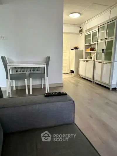 Modern living room with sleek furniture and open kitchen layout