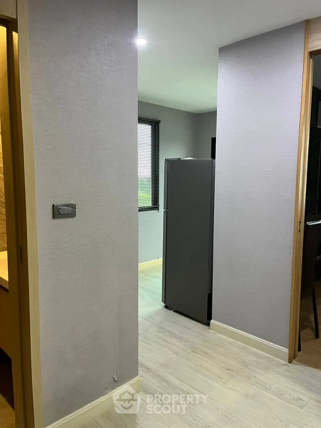 Modern apartment hallway with sleek refrigerator and stylish decor