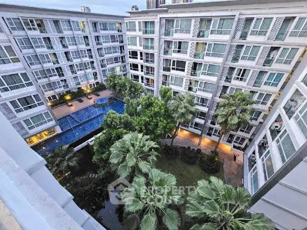 Modern apartment complex with lush garden and pool view