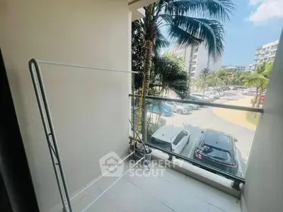Charming balcony with tropical view and ample space for relaxation.