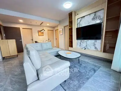 Modern living room with sleek furniture and marble accent wall, perfect for stylish urban living.