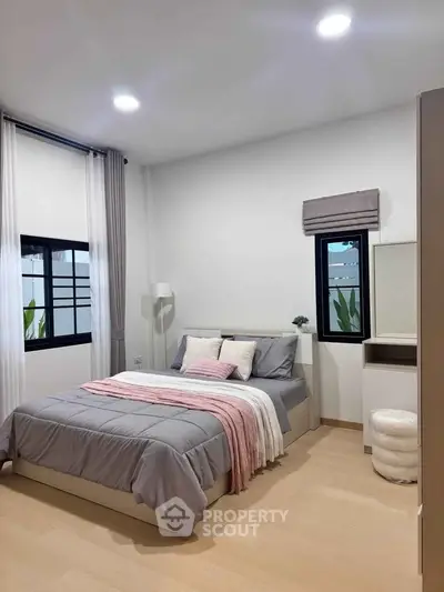 Modern bedroom with stylish decor and natural light