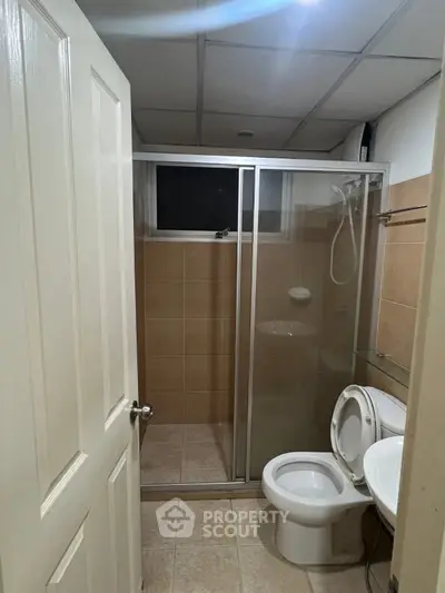 Compact bathroom with shower enclosure and modern fixtures, ideal for small apartments.