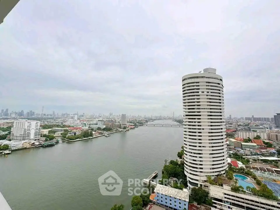 Stunning river view from high-rise building showcasing city skyline and waterfront living.