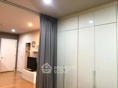 Modern apartment interior with sleek wardrobe and cozy living area
