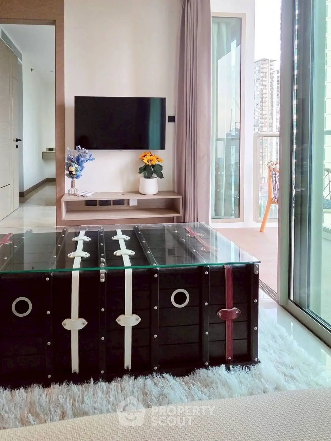 Modern living room with stylish decor and balcony view