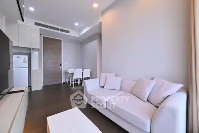 Modern living room with sleek furniture and open kitchen layout