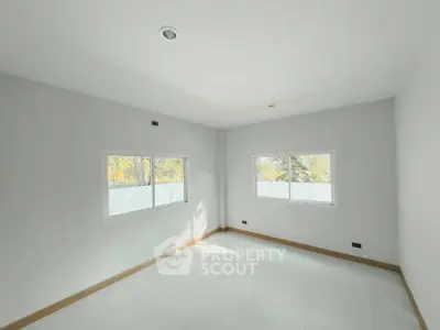 Bright and spacious empty room with large windows and white tiles