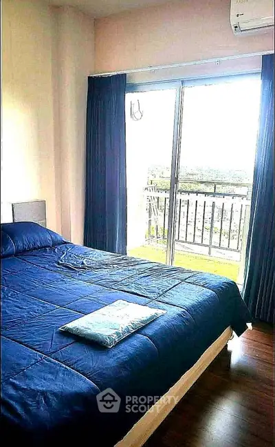 Spacious bedroom with large window and balcony access offering stunning views.