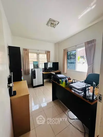 Bright home office with large windows and modern furniture