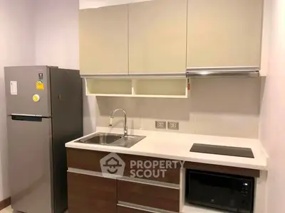 Modern kitchen with sleek cabinetry and built-in appliances in a contemporary apartment.