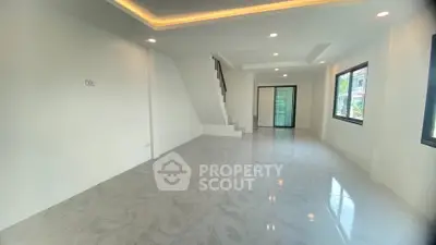 Spacious modern living room with sleek tile flooring and ample natural light.