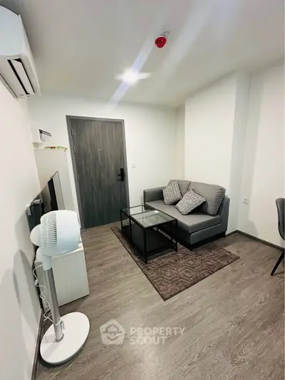 Modern living room with sleek furniture and stylish decor in a contemporary apartment.