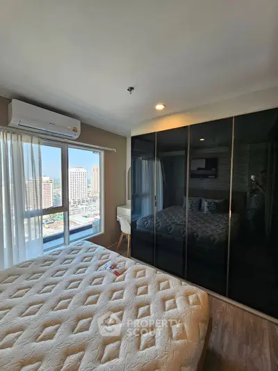 Modern bedroom with city view, large window, and sleek black wardrobe.