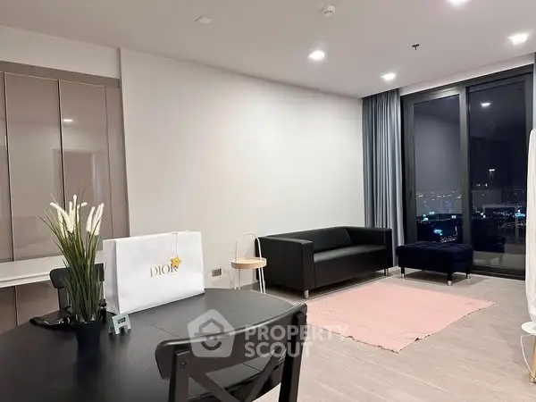 Modern living room with sleek furniture and city view, perfect for urban living.
