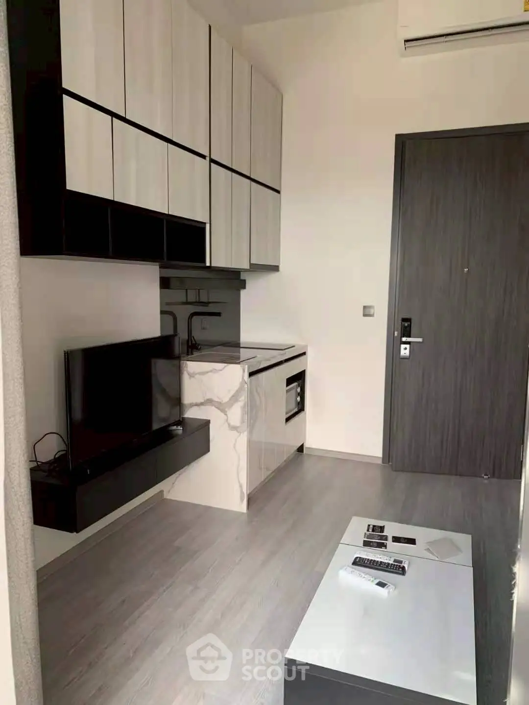 Modern compact living room with sleek kitchen and stylish cabinetry
