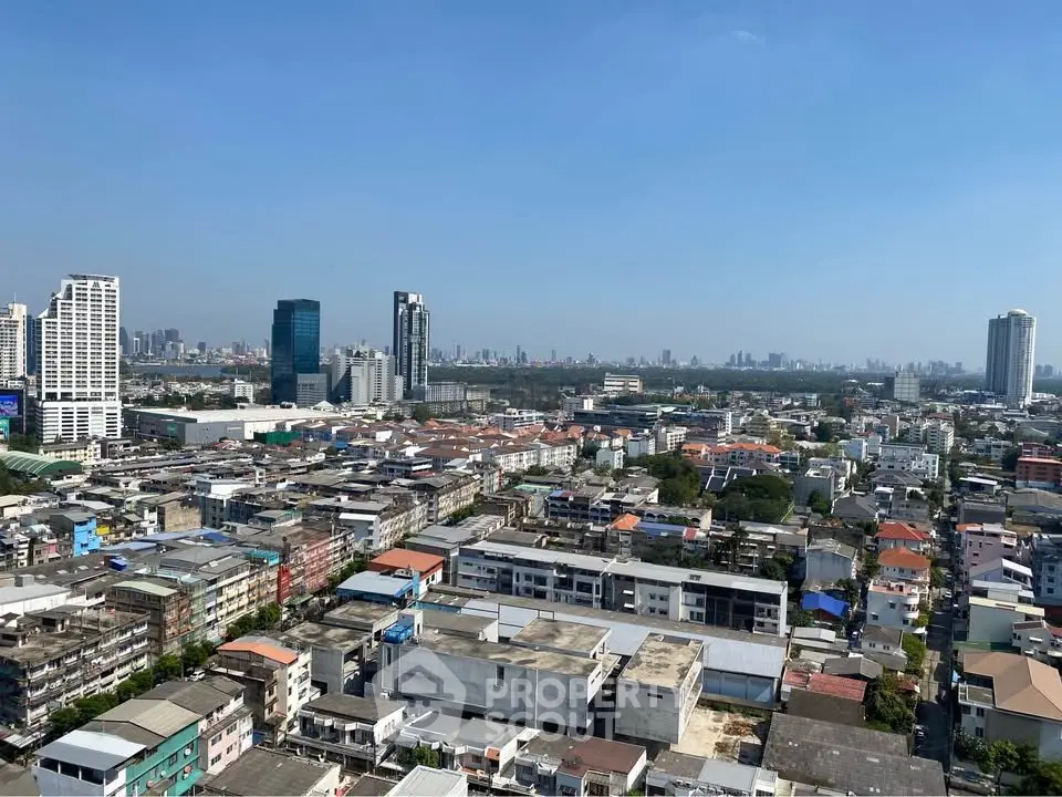 Stunning cityscape view showcasing urban skyline and residential buildings under a clear blue sky.