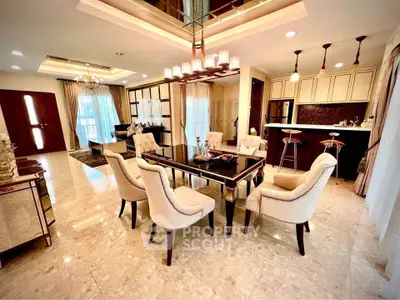 Luxurious open-plan living and dining area with elegant furnishings and modern lighting.