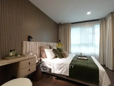 Luxurious bedroom with elegant decor and natural light, featuring plush bedding and stylish furnishings.