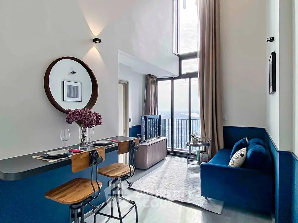 Modern living room with high ceilings, large windows, and stylish decor in a luxury apartment.