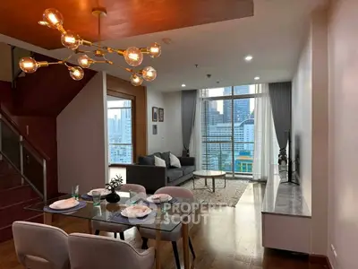 Modern living room with city view, stylish lighting, and elegant dining area in a high-rise apartment.