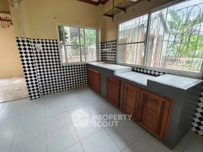 Charming kitchen with checkered tiles and wooden cabinets, offering a cozy and inviting atmosphere.