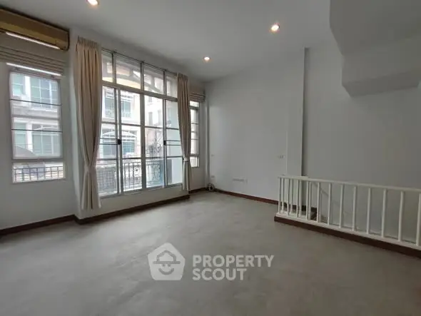 Spacious living room with large windows and natural light in modern apartment