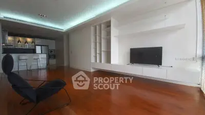 Spacious modern living room with sleek built-in shelves and open kitchen layout