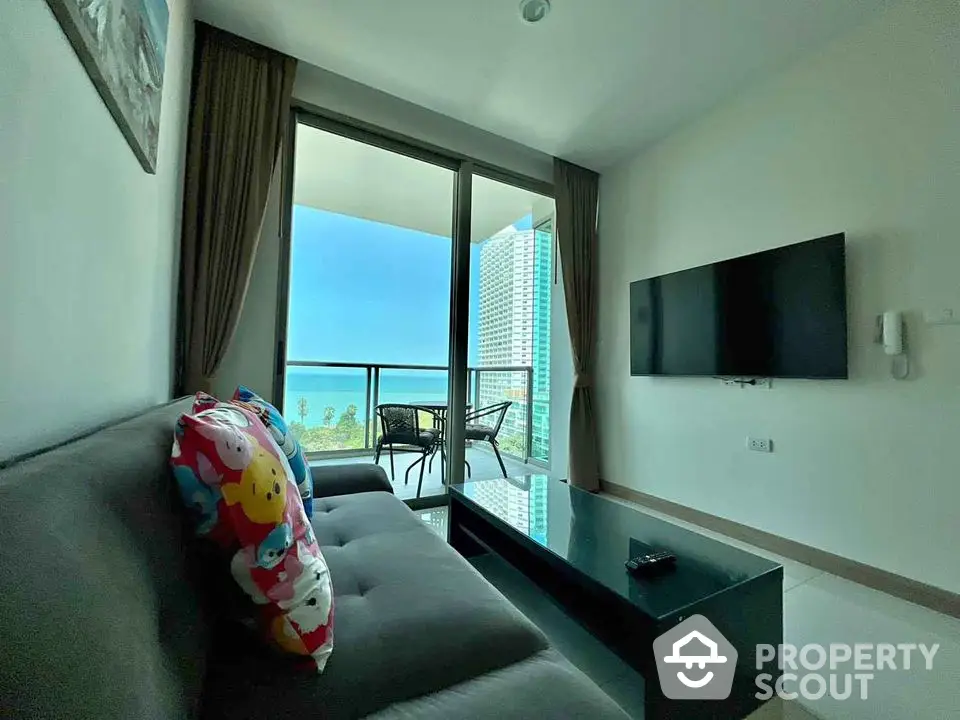 Modern living room with ocean view and balcony in high-rise apartment