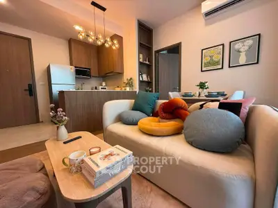 Modern living room with cozy decor and open kitchen layout, perfect for stylish urban living.