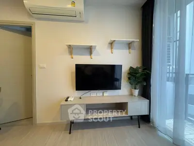 Modern living room with wall-mounted TV, air conditioning, and stylish decor