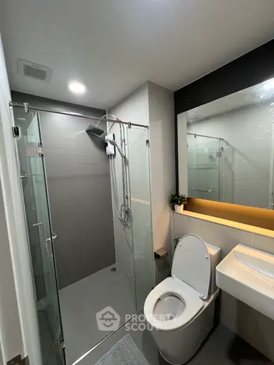 Modern bathroom with sleek design, glass shower, and contemporary fixtures