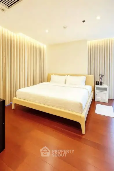 Luxurious bedroom with elegant lighting and wooden flooring