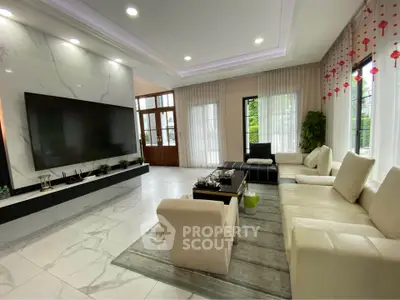 Luxurious modern living room with marble flooring and large TV, perfect for entertaining.